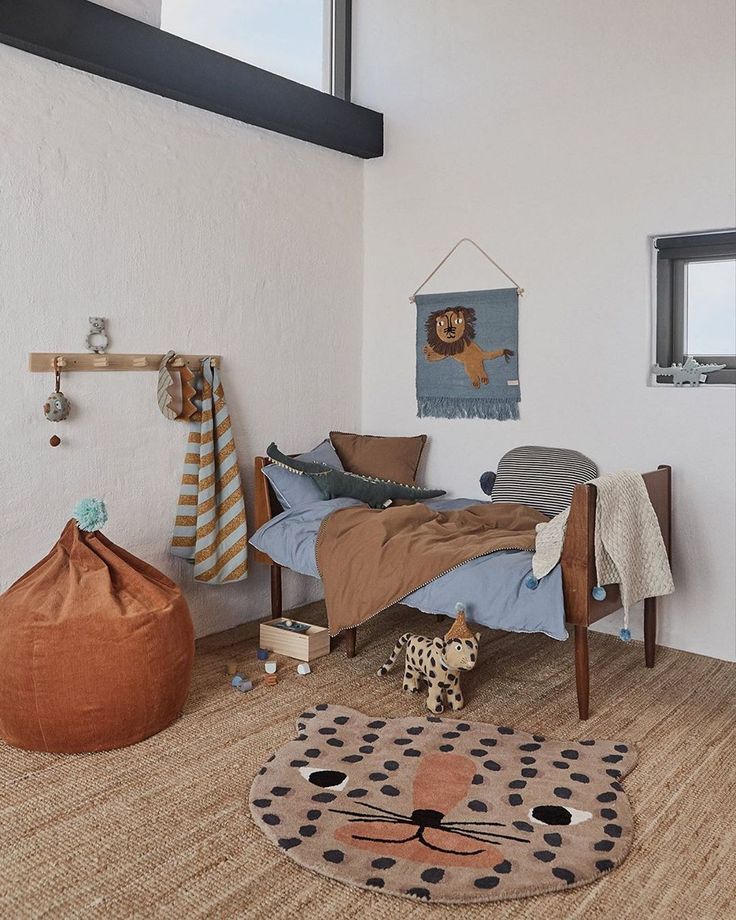 a room with a bed, chair and rug in it