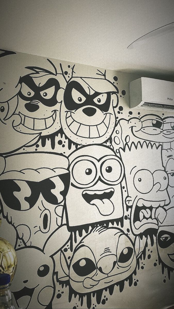 a wall with cartoon faces painted on it and an air conditioner in the background