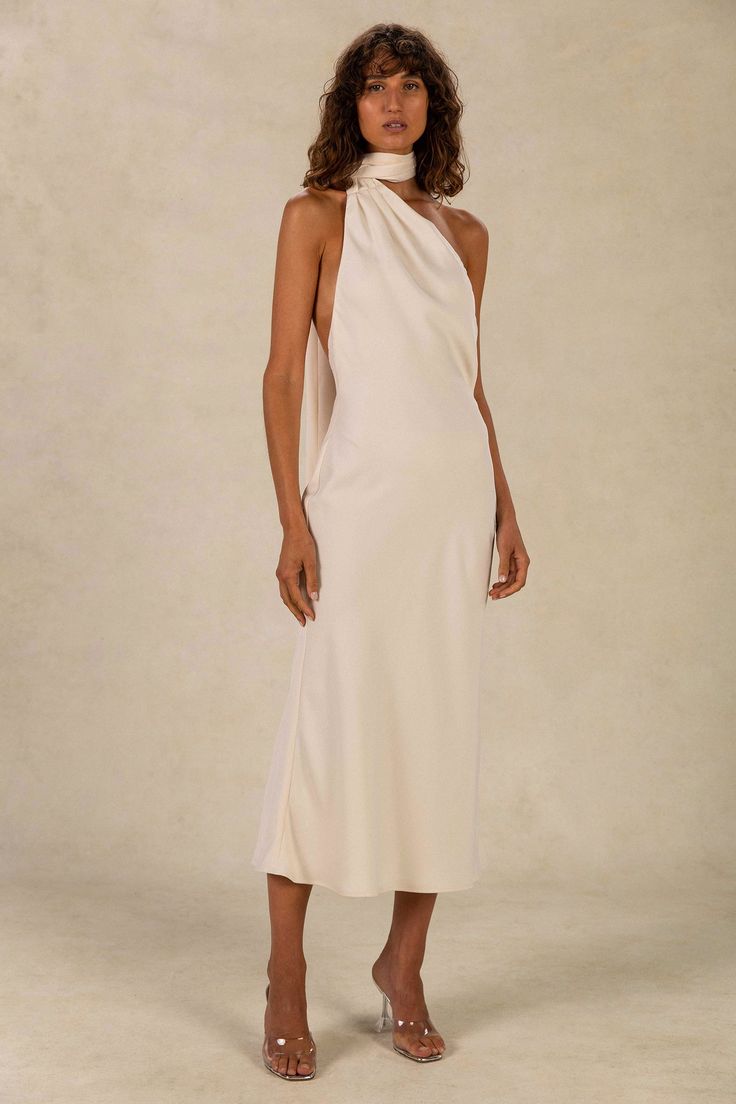 a woman is wearing a white dress with one shoulder and an asymmetrical neckline