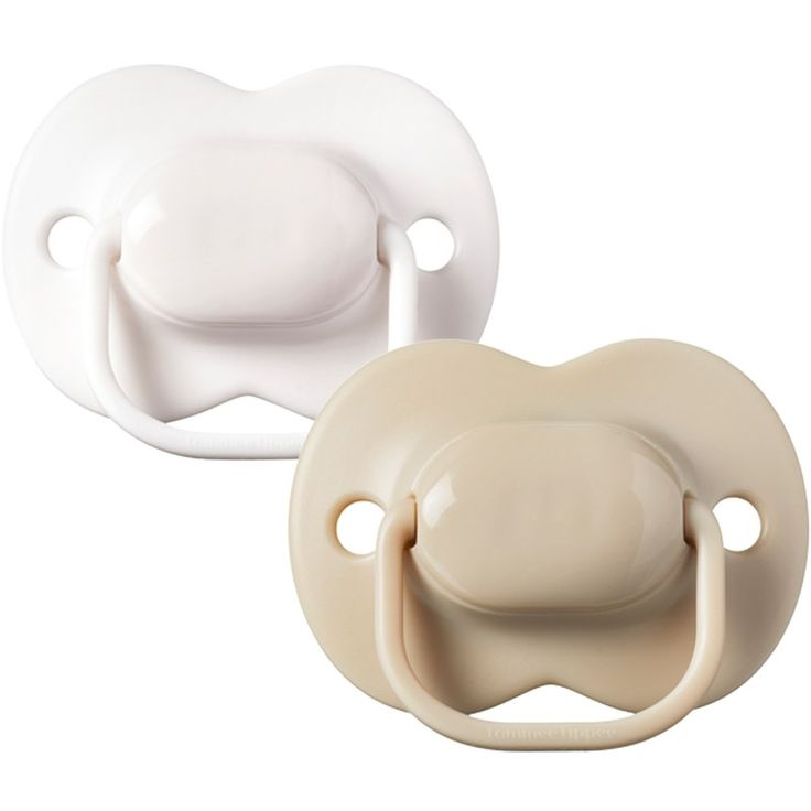 two baby pacifiers sitting next to each other