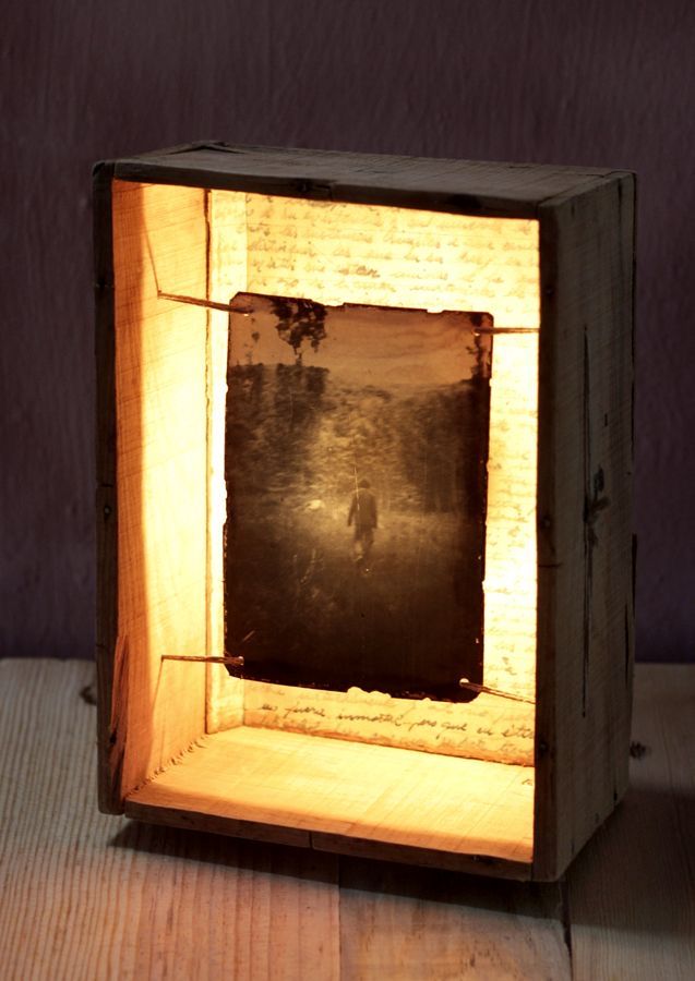 a small wooden box with a light inside