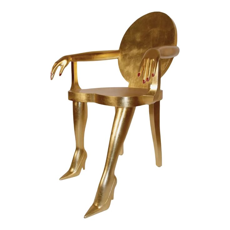 a gold colored chair with a woman's legs sticking out from the back and arms