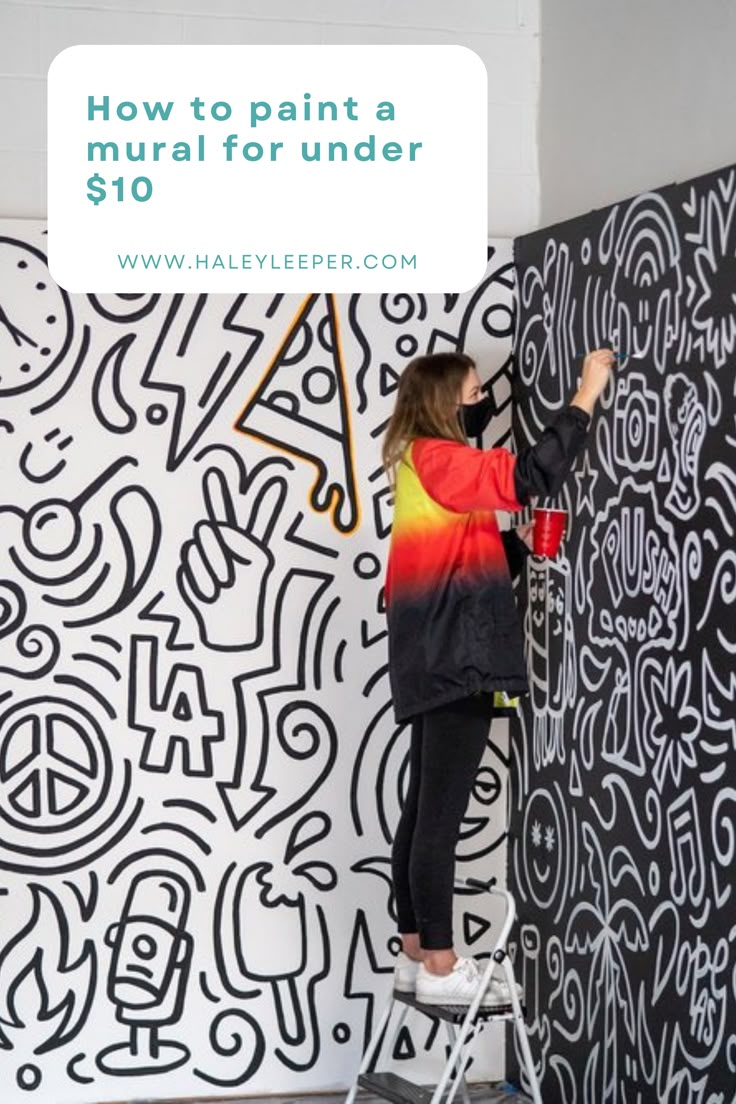 a woman painting a mural on the side of a wall with words how to paint a mural for under $ 10