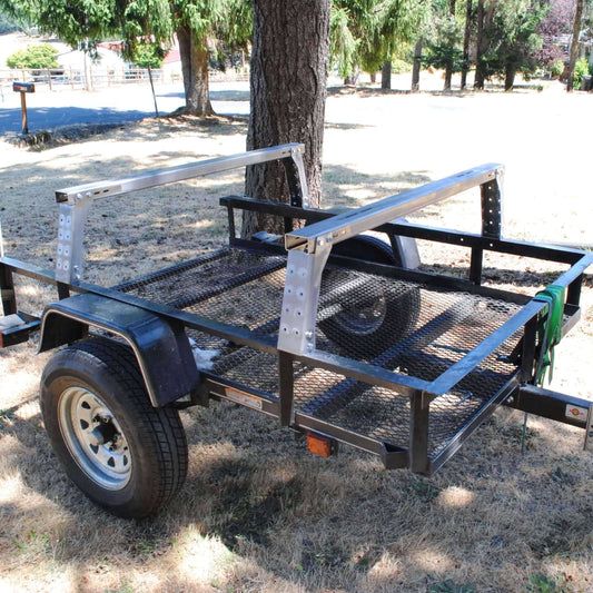 a trailer attached to a tree in the grass