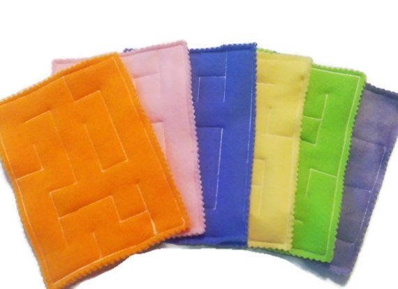 four different colors of fabric with squares on each side and one square in the middle