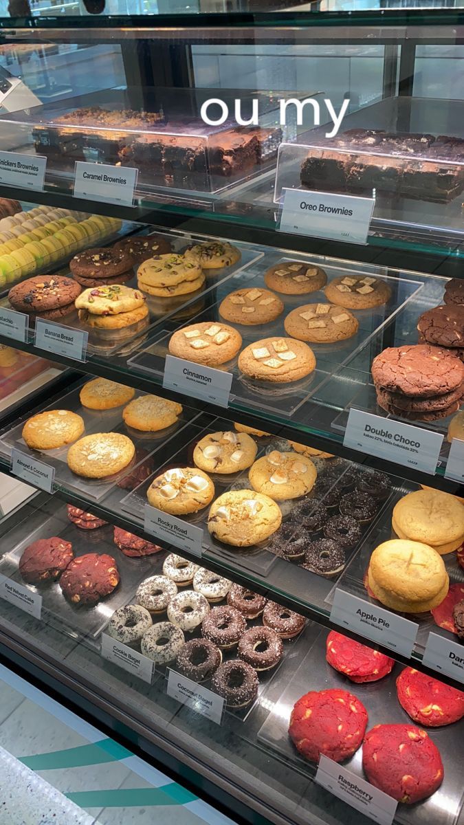 a display case filled with lots of different types of doughnuts and pastries