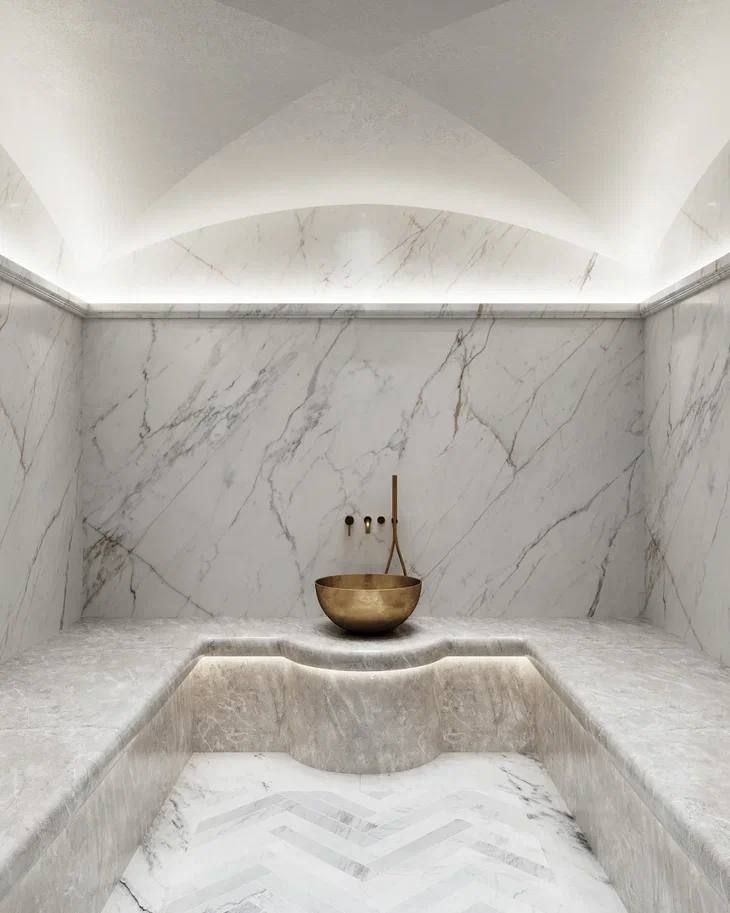 a bath room with a bowl on the counter and two candles in the corner next to it