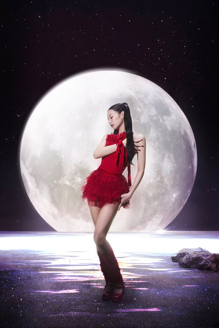 a woman in a short red dress and boots posing for a photo with the moon behind her