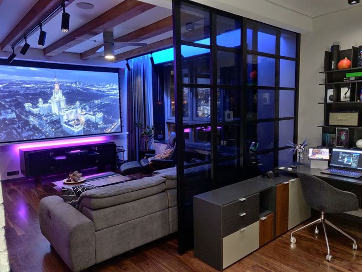 a living room filled with furniture and a flat screen tv mounted to the side of a wall