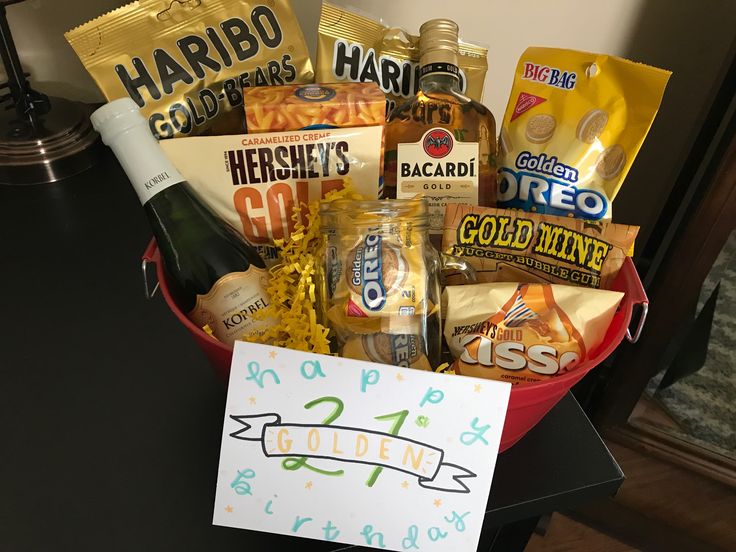 a basket filled with snacks and drinks on top of a table next to a sign