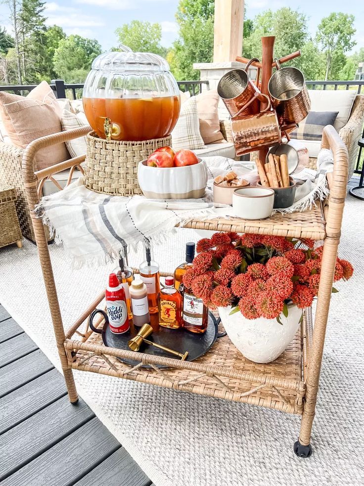 an outdoor table is set up with food and drinks for entertaining on the deck or patio