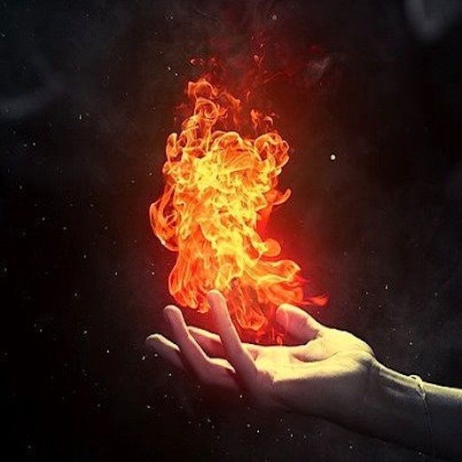 a person holding out their hand with fire in the air above it and on top of them