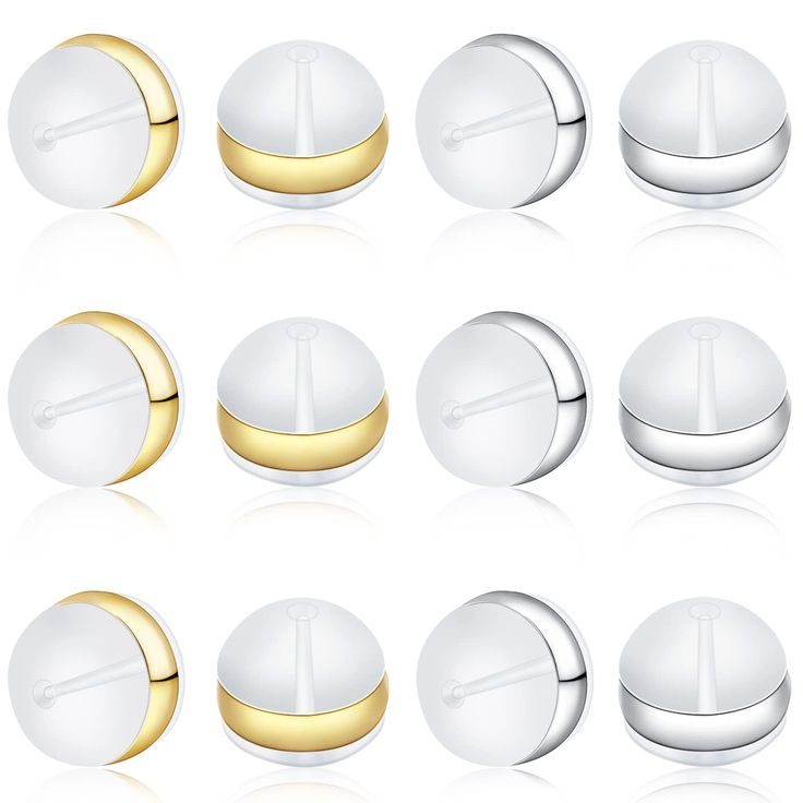 a set of white and gold buttons on a white background with some reflection in the middle