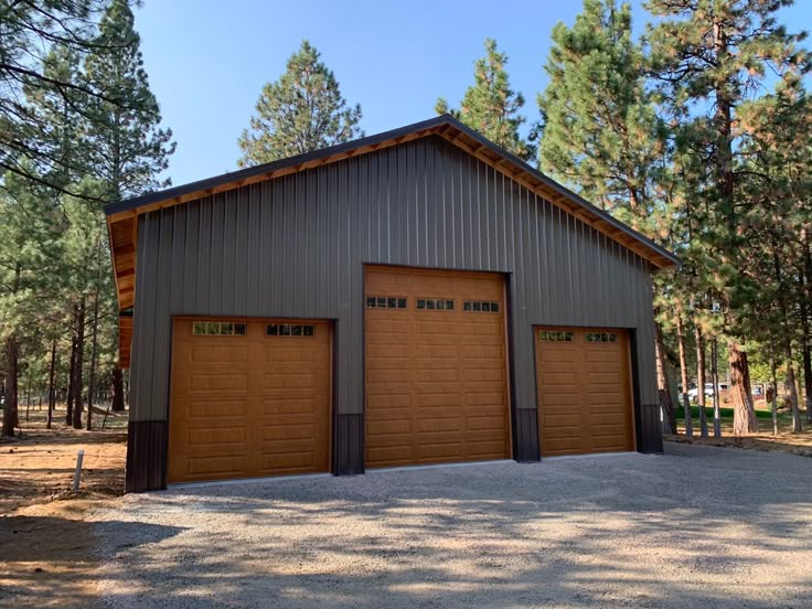 two garages are shown in the middle of a wooded area with trees around them