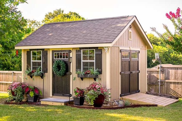 a garden shed with potted plants in it