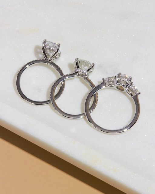 two silver rings sitting on top of a white counter