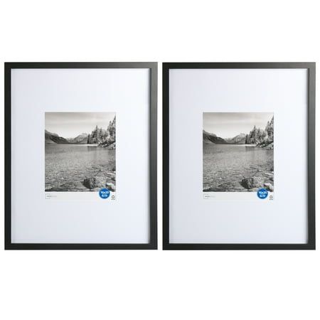 two black and white framed pictures with mountains in the background, one has a blue button on it