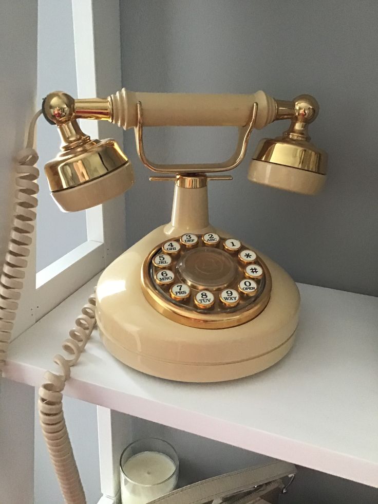 an old fashioned phone sitting on top of a shelf