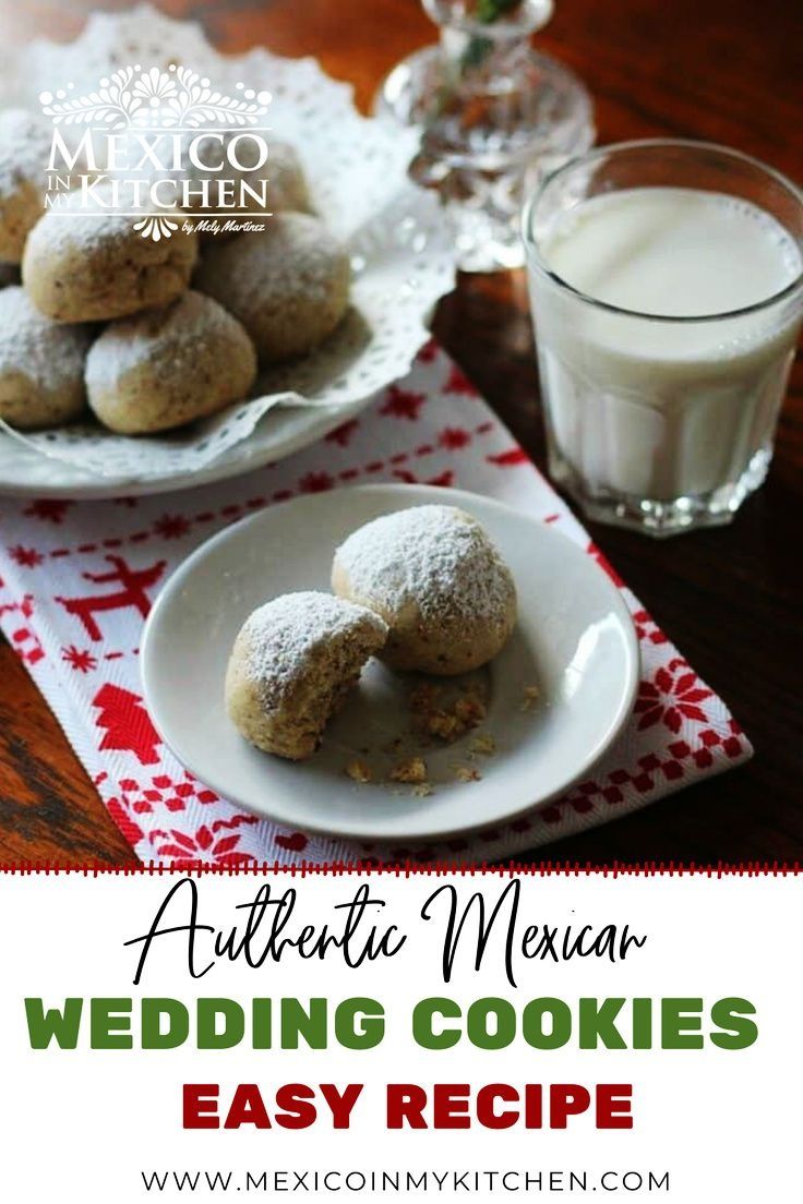 mexican wedding cookies on a plate next to a glass of milk