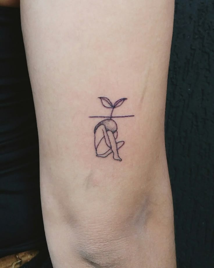 a woman's arm with a small tattoo on the left side of her body