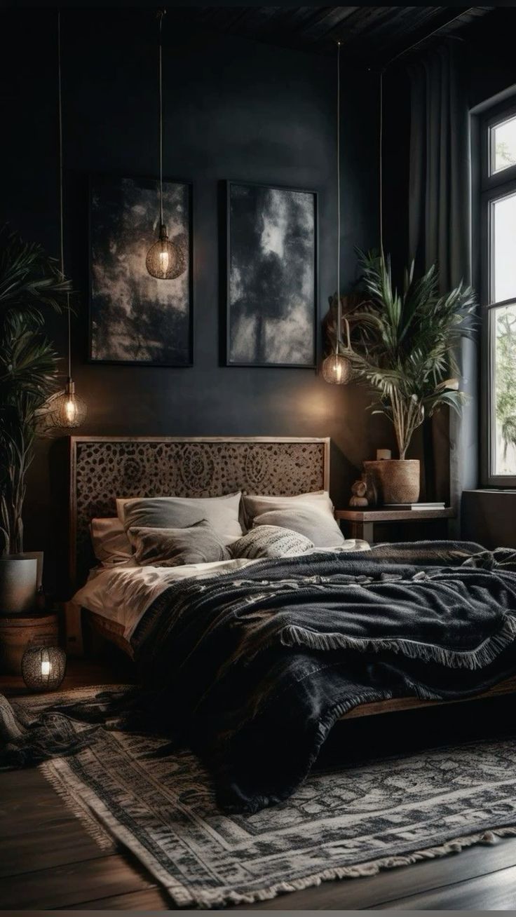 a bedroom with black walls and wooden floors, large bed surrounded by two potted plants