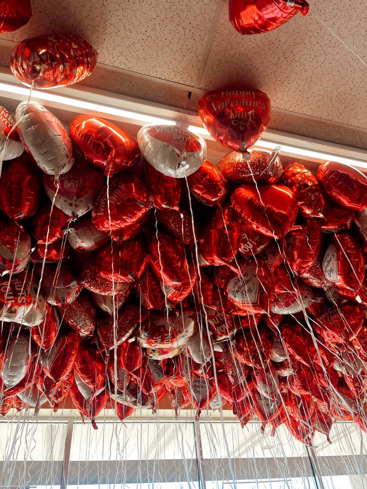 red heart shaped balloons hanging from the ceiling