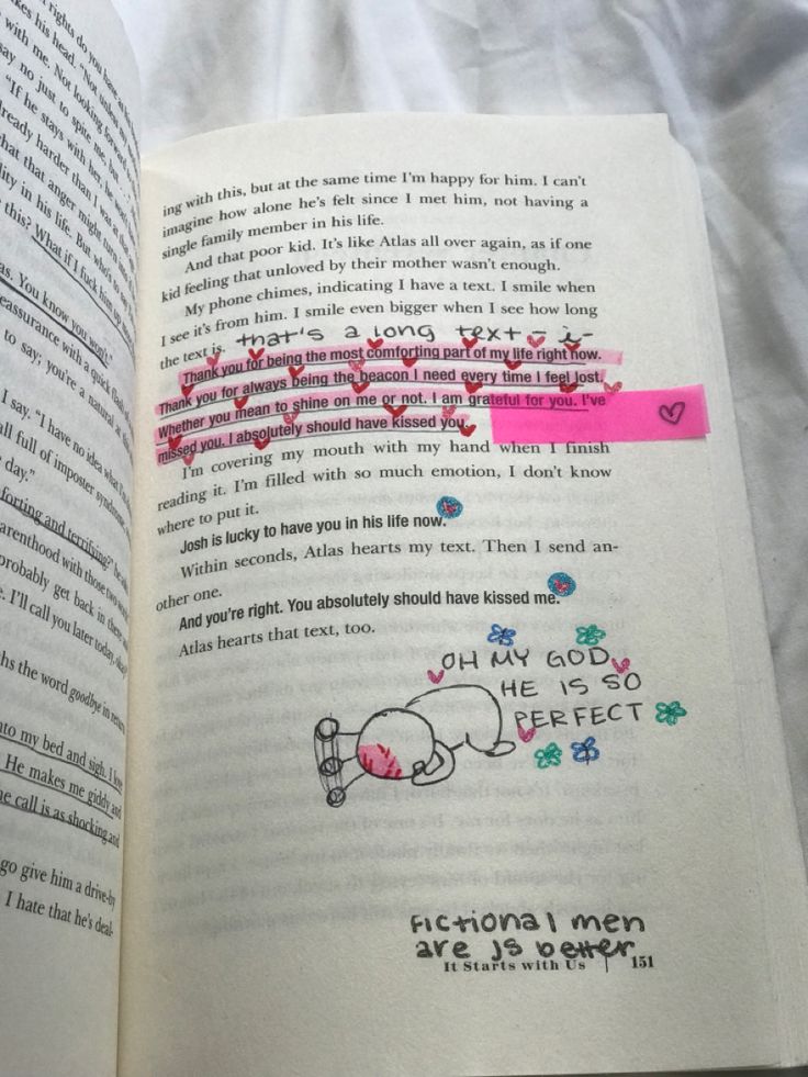 an open book with writing on it and some stickers attached to the pages in pink