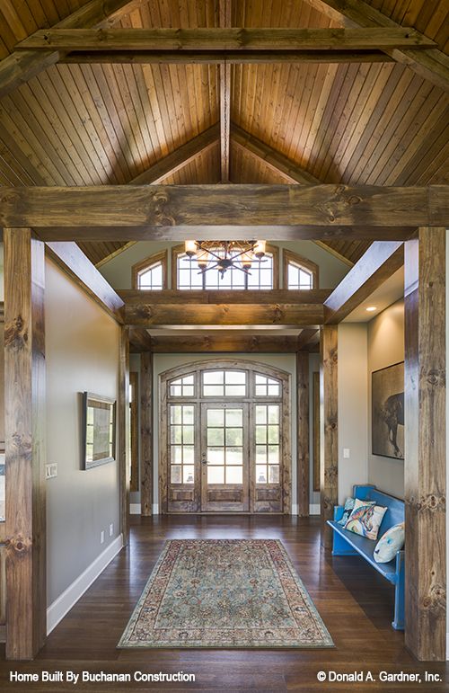 the inside of a house with wood floors and wooden beams on the ceiling is shown