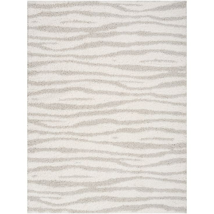 a white rug with wavy lines on the top and bottom, in shades of grey