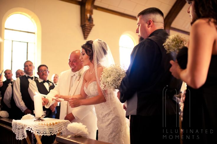 the bride and groom are getting ready to cut their wedding cake at the altar together