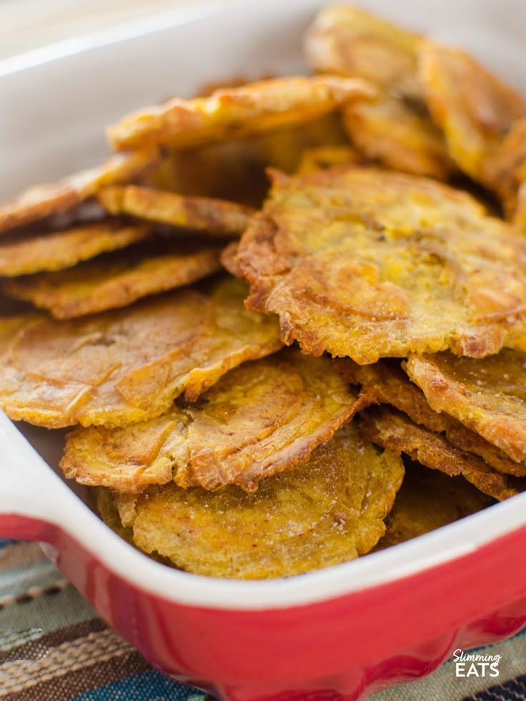 a red dish filled with fried food on top of a table