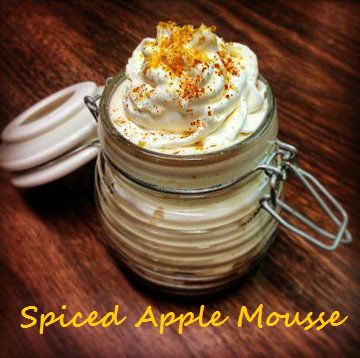 a jar filled with whipped cream sitting on top of a wooden table