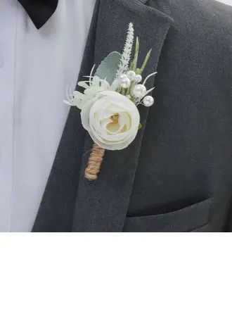 a boutonniere with white flowers and greenery is worn on the lapel of a man