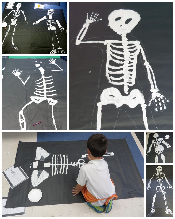 the skeleton is being made with construction paper and glue to make it look like he's doing something