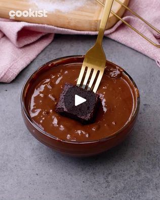 a fork sticking into a chocolate dessert in a bowl