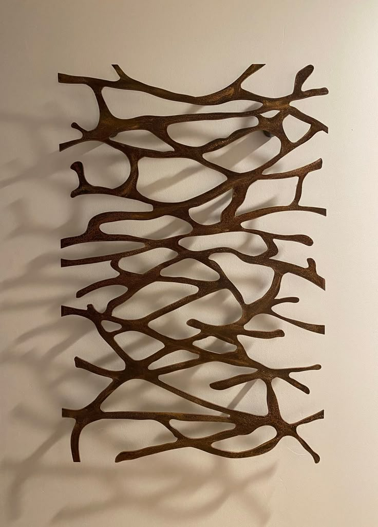 a metal sculpture is hanging on the wall