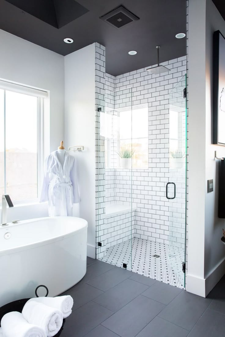 a bathroom with a large white tub next to a walk in shower