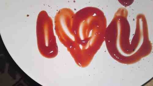 the word love spelled with red sauce on a white plate