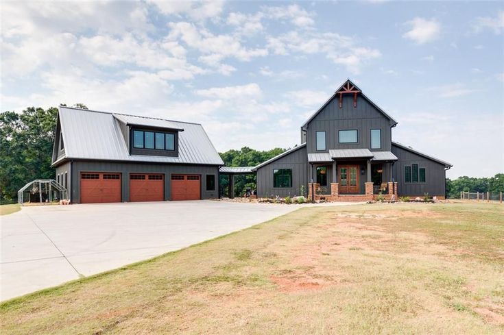 a large house with two garages on the side