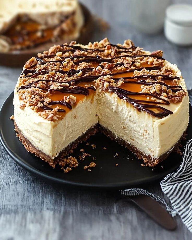 a cheesecake on a black plate with one slice cut out