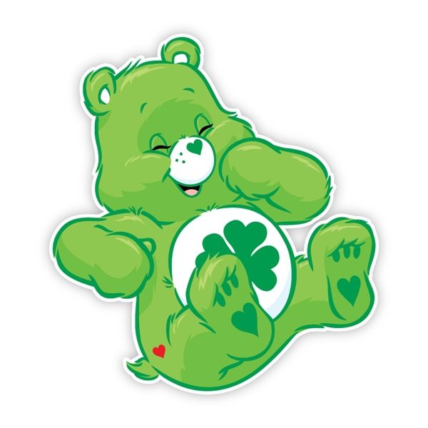 a green teddy bear sitting on its hind legs holding a four leaf clover sticker