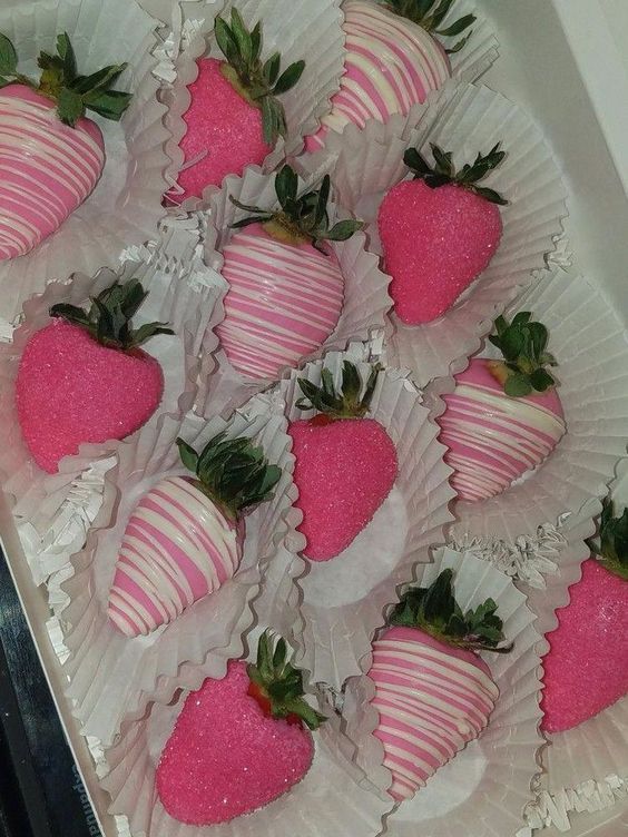 a box filled with lots of pink and white strawberries on top of each other