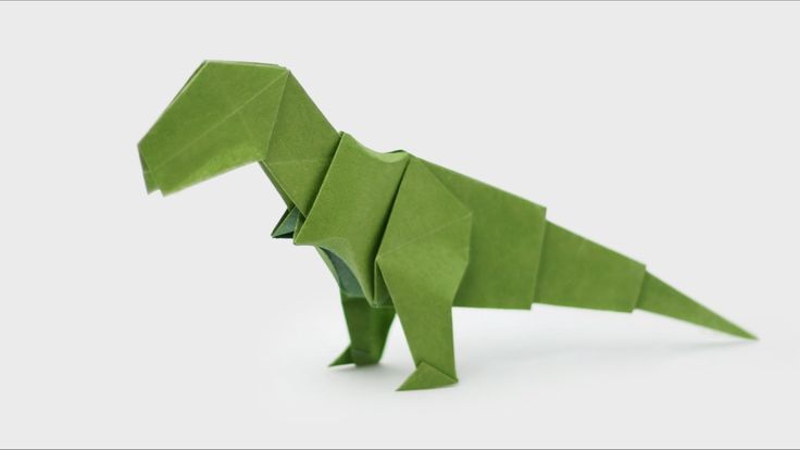 an origami dinosaur made out of green paper