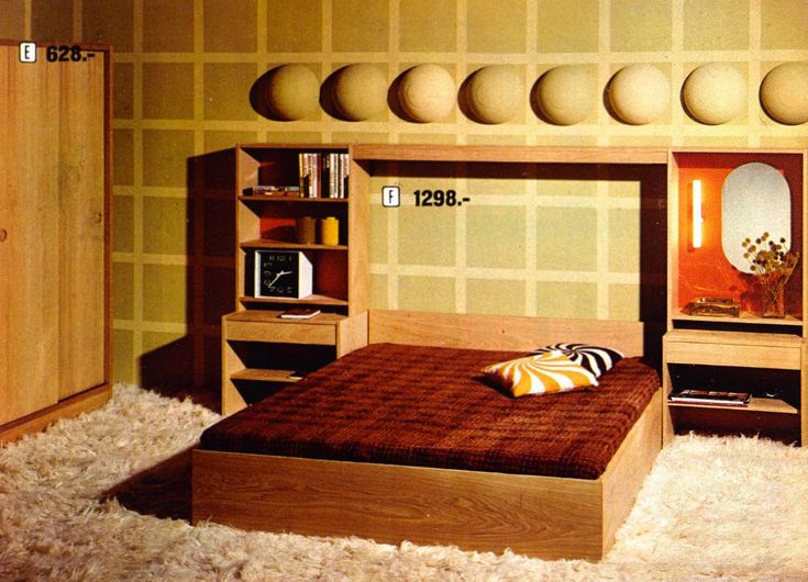 a bed room with a neatly made bed and shelves