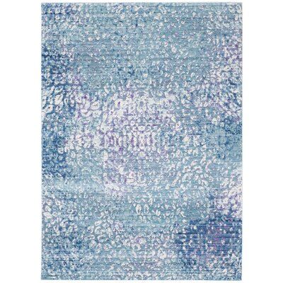 a blue and white rug with an abstract design on the bottom, it is very soft