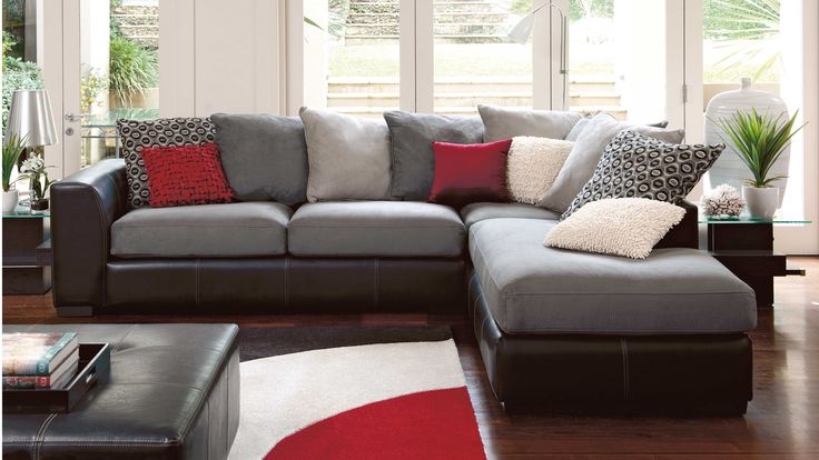 a living room filled with furniture and lots of windows