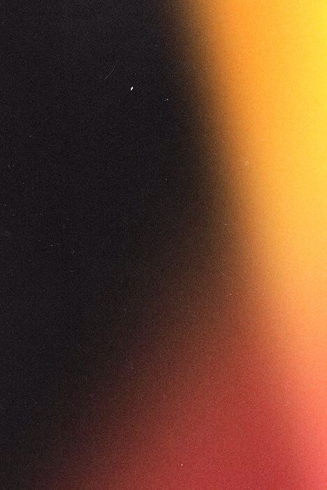 a blurry image of an orange and yellow object