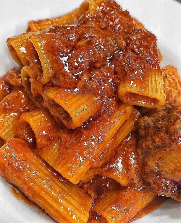 pasta with meat and sauce in a white bowl