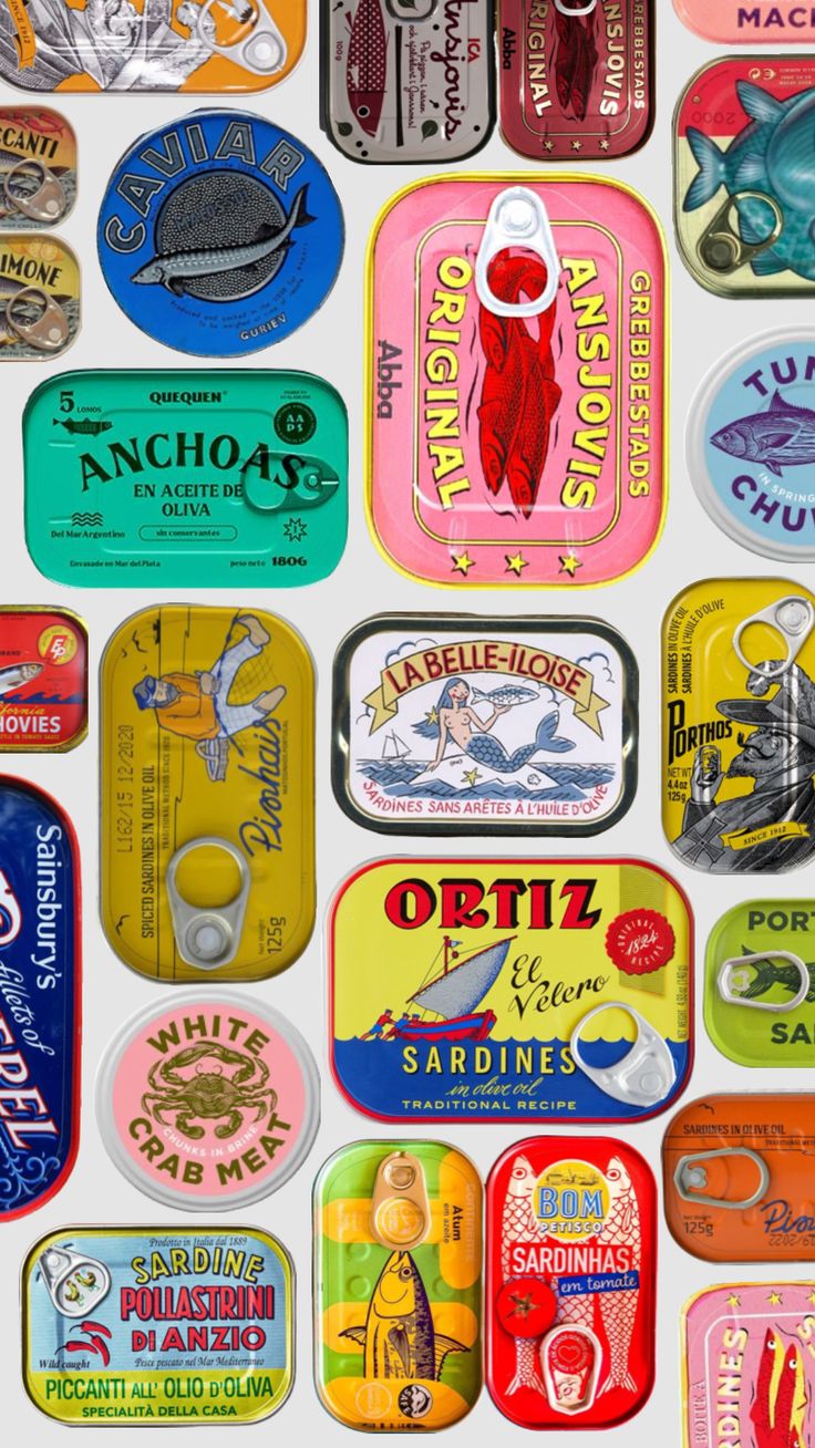 an assortment of tins that are all different colors and sizes, including one with a fish on them