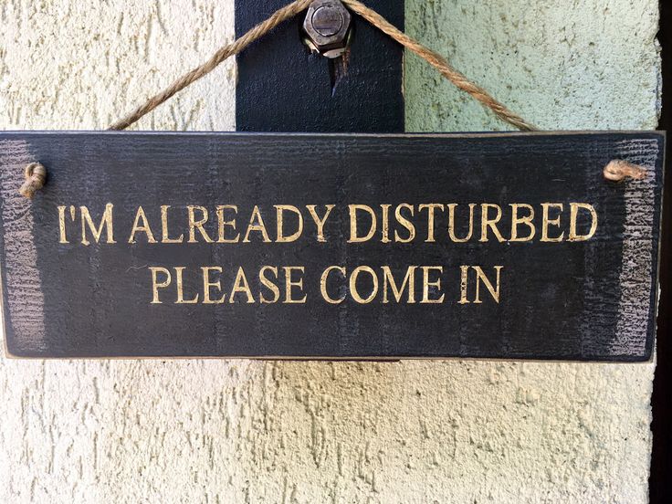 a sign that says i'm already disturbed please come in hanging on the wall